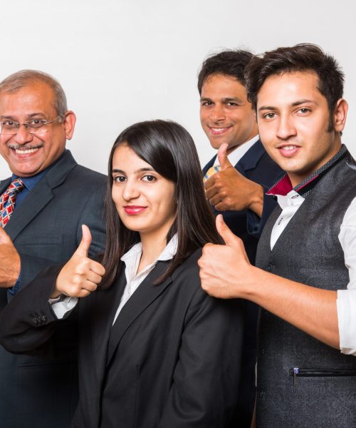 Indian smart Business people OR lawyer in suit standing as a team, isolated over white background, looking at camera Indian smart Business people OR lawyer in suit standing as a team, isolated over white background, looking at camera