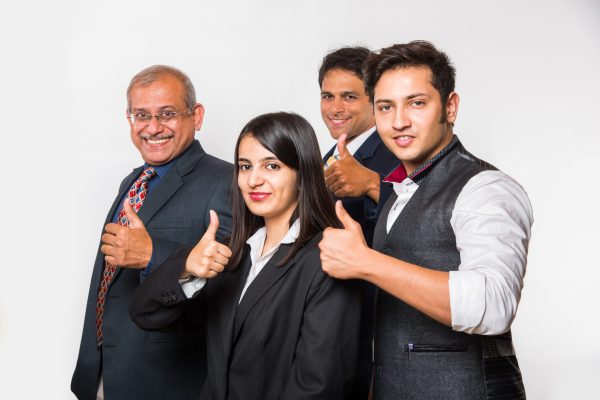 Indian smart Business people OR lawyer in suit standing as a team, isolated over white background, looking at camera Indian smart Business people OR lawyer in suit standing as a team, isolated over white background, looking at camera